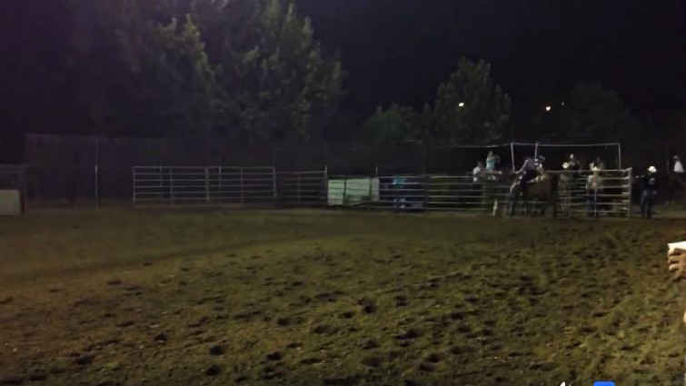 Georgia Stepp riding horse with American flag at rodeo
