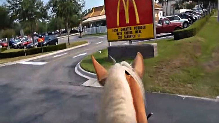 Horse riders at McDonald's drive-thru