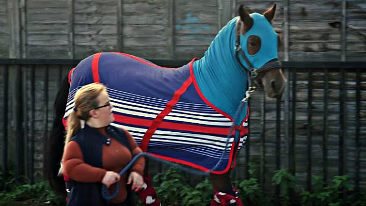 Megan Gregory riding horse with dwarfism