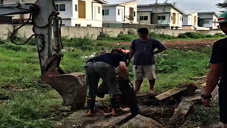 Rescue team working on expanding the drainage hole
