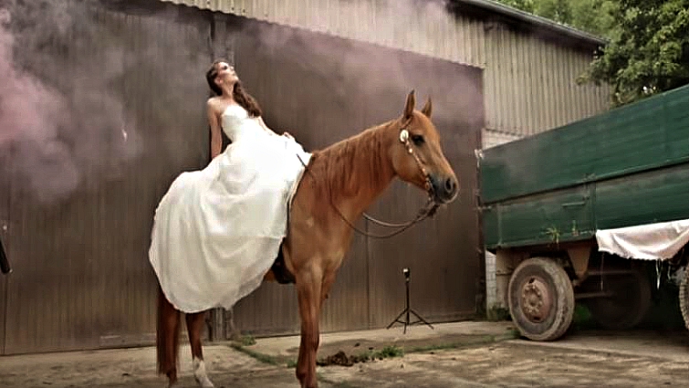 Bride with horse in atmospheric smoke and water