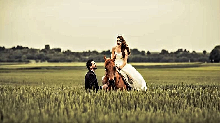 Horse and couple in wedding photoshoot with water effects