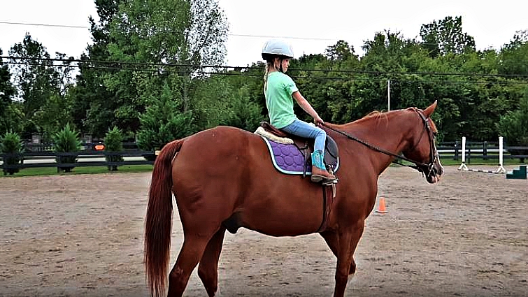 Maya confident and smiling while riding