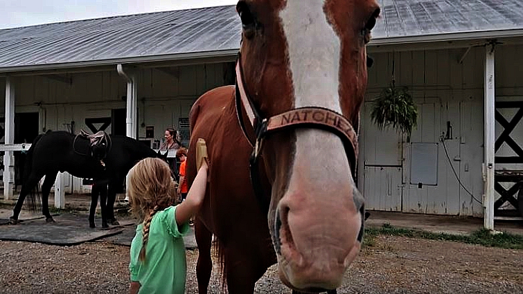 Maya and her horse after successful ride